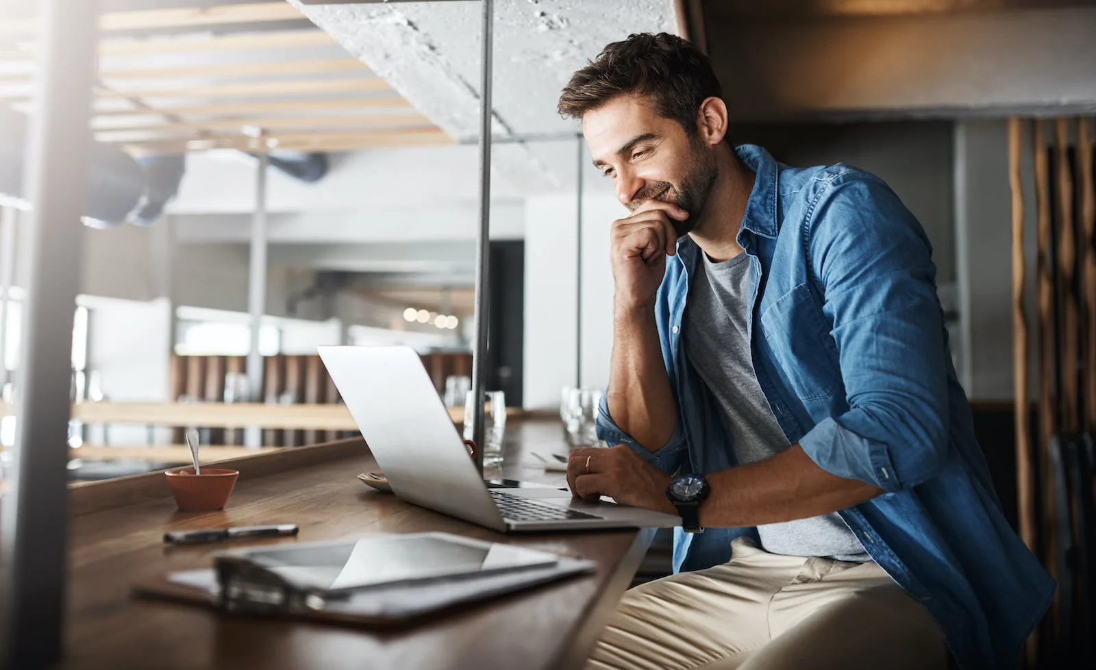 man smiling at laptop